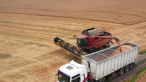 Aerial view countryside farmland. Industrial machinery gathering.