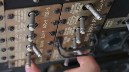 Hand Flips Switches on Panel