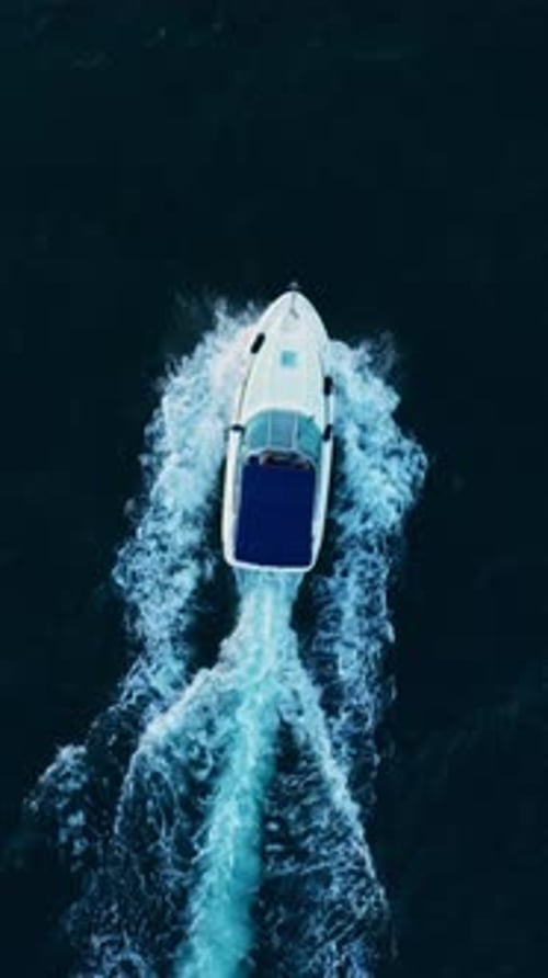 Aerial view to motor yacht floating in sea