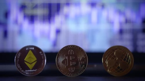 A Varied Display of Cryptocurrency Coins Accompanied By a Market Background That Highlights Trends