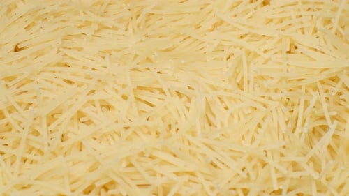 A Pile of Raw Yellow Pasta Spins in a Circle