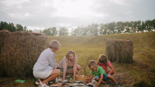 Family Picnic with Dog in Rural Field