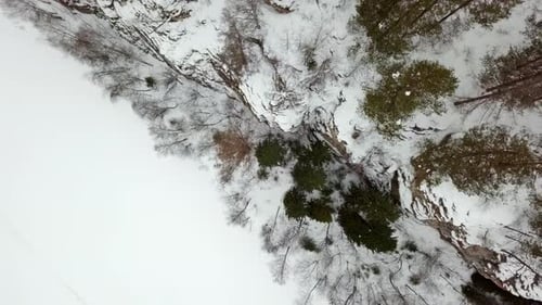 A Breathtaking Aerial View Showcasing the Stunning Beauty of a Snow Covered Landscape and Forest