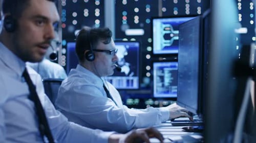 In the System Control Center Technical Support Team Gives Instructions with the Help of the Headset