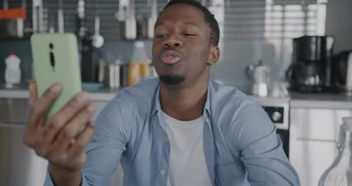 Young Adult Video Calling in a Modern Kitchen