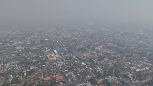 Aerial drone view of Chiang Mai covered in smog during burning season, highlighting severe air