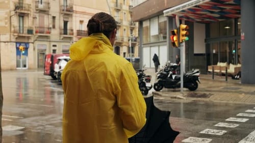 Business Man Tourist Person with Umbrella and Raincoat on Rainy European City Street Lights