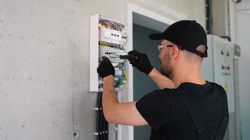 Electrician Installing Electrical Panel in Office or House