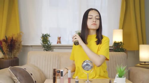 Young Woman Sprays Perfume at Home
