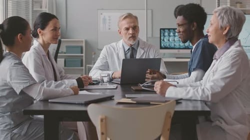 Doctors Collaborate at Meeting in Medical Office