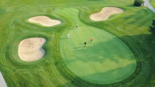 A Group of Four Men Play Golf at a Prestigious Country Club Top View of Golf Course and Four Players