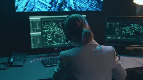 Woman Working at Computer with Multiple Screens