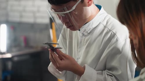 Lab Technician Examining Measurement Data in Automotive Workshop