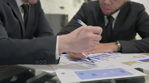 Close up of Businessmen Working on Documents