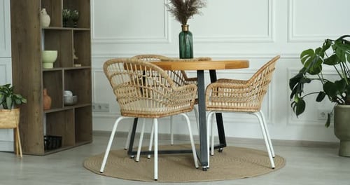 Modern dining room setup with wicker chairs