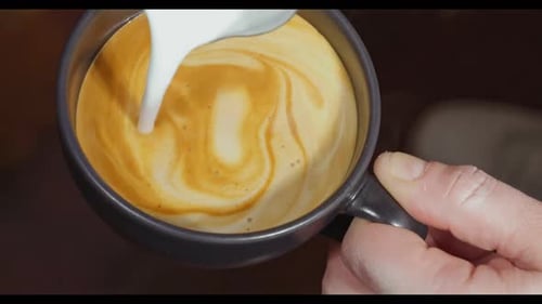 Pouring Milk Into Coffee Close Up Shot