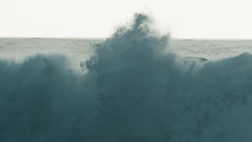 Stormy Ocean Wave Breaks on the Shore at Sunrise