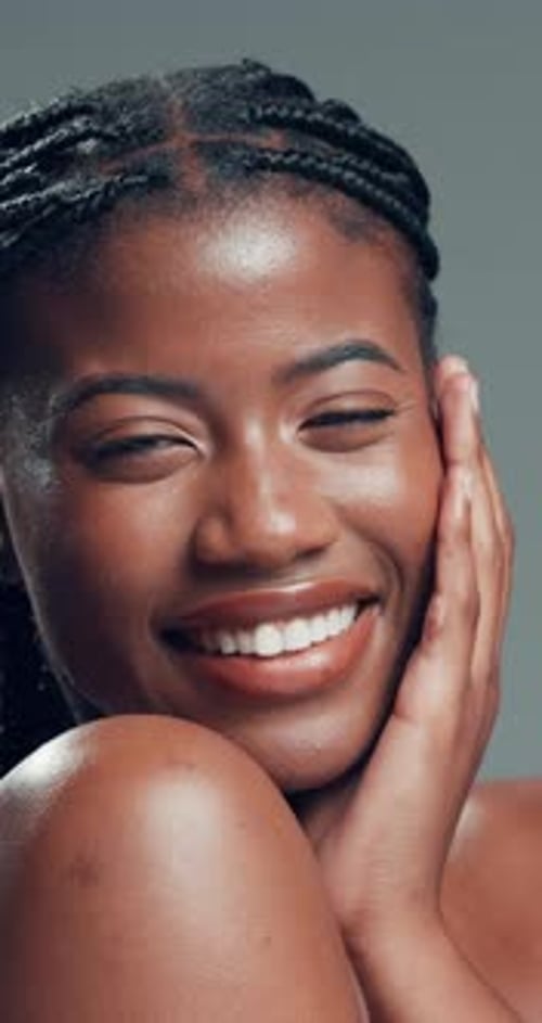Skincare, face and funny black woman with glow, beauty or self care on gray background in studio
