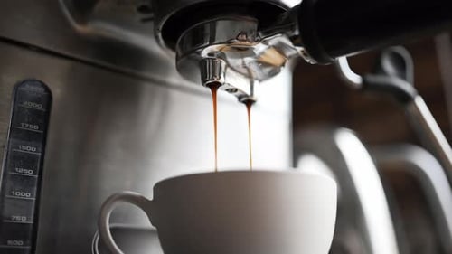Espresso Machine Pouring Coffee into White Mug