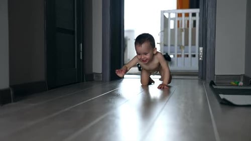Happy Infant Crawling on Floor at Home