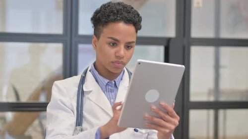 Female Doctor Using Tablet Technology in Hospital