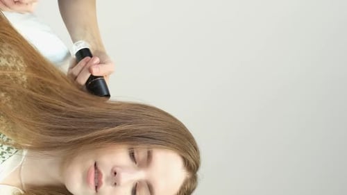 Young Woman Gets Hair Styled in Beauty Salon