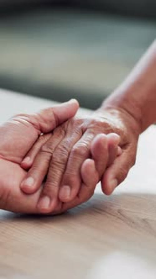 Loving Touch: Senior Adult Holding a Child's Hand