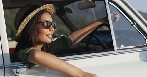 4k video footage of a young attractive woman on a road trip