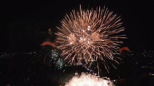 Spectacular Fireworks Display Illuminating the Night Sky Over a Vibrant City Waterfront with