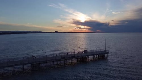 Side View of the Pier on the Black Sea Against the Background of the Sky and Sunset