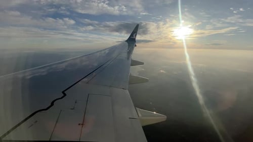 Wing and sky view from airplane window