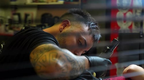 Tattoo Artist Focused on Tattooing