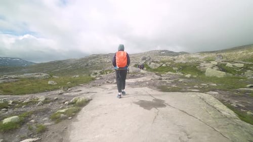 guy travels on a beautiful mountain road in norway