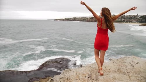 Girl Put Hands In The Air As She Watches The Crashing Waves In The Rocks - Eastern Suburbs, Sydney,
