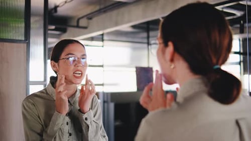 Woman Practicing Speech in Front of Mirror