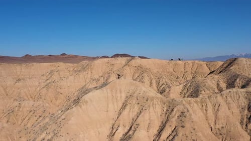 Cinematic revealing drone shot of a person doing a handstand in the Charyn Canyon, Kazakhstan