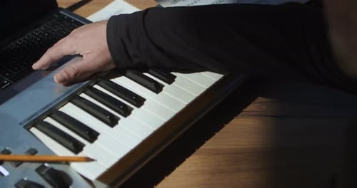 A person composes and records a song on a computer. Switches on the recording on the computer and pl