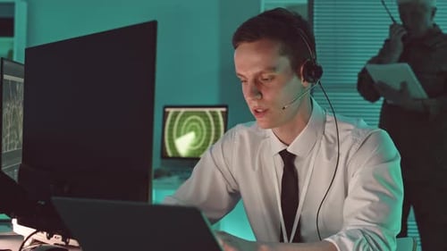 Young Adult Operator Works at Computer Station