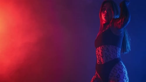 Woman Dancing in Colorful Studio with Smoke