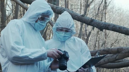 Forensic Specialist Working in the Forest Police Criminalists Collecting Evidence and Making