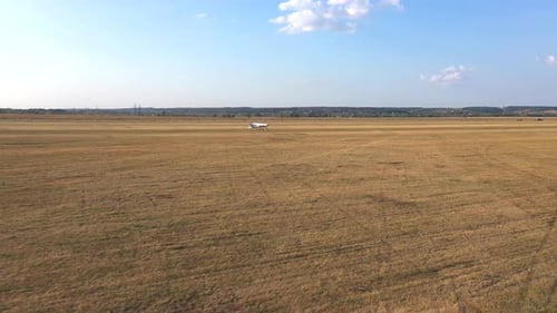 Small Airplane Takes Off From Grass Airstrip of Small Airport