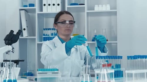 Scientist Examining Test Tubes in a Lab