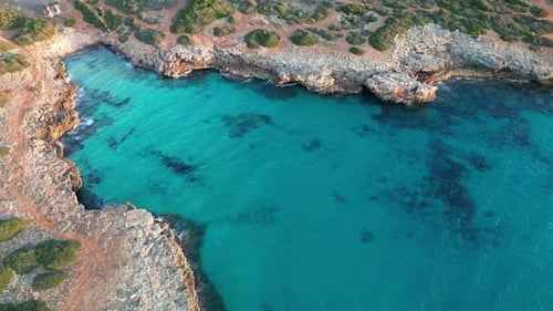 Stunning View Of Turquoise Seawater Of Cala Petita During Summertime In Mallorca, Spain. aerial top-