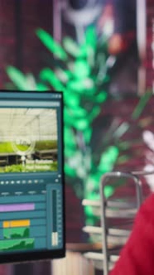 Vertical Video Video Creator Woman Editing a Music Video on Dual Monitors in Loft Studio