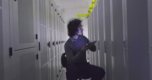 Adult Working With Tablet in Data Center