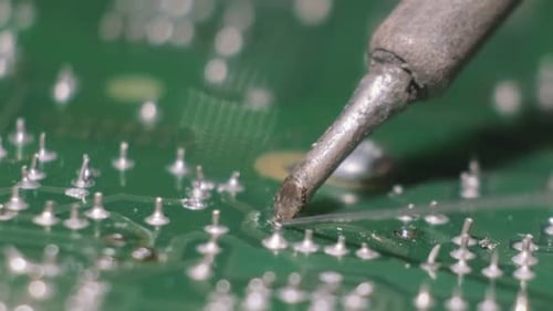 Using a Soldering Iron for Repairing Parts of the Computer Circuit Board