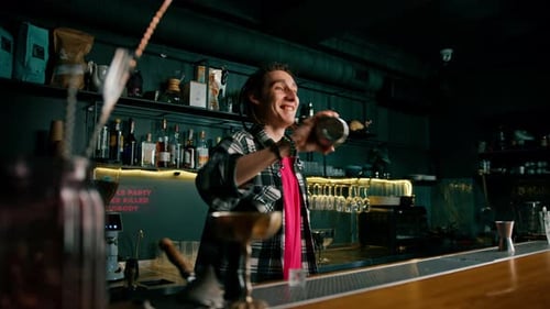 The process of making a cocktail in a bar A bartender mixes the ingredients of an alcoholic cocktail