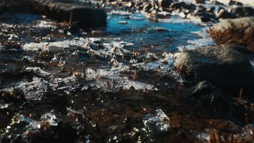 A River Flowing Through a Rocky Landscape with Abundant Rocks