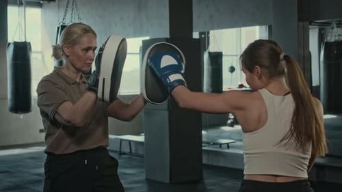 Women Training Boxing in Gym