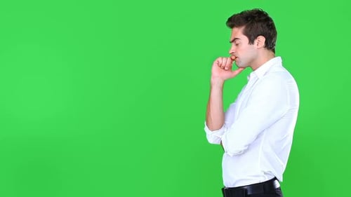 High definition video of a young man looking bored and frustrated against a green screen